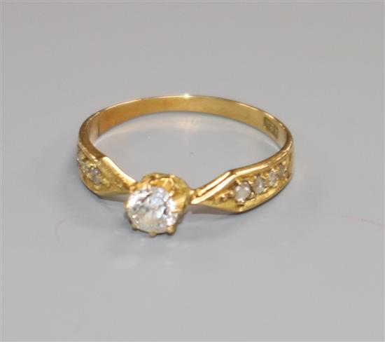 An early 20th century 18ct gold and single stone diamond ring, with diamond set shoulders, size K.